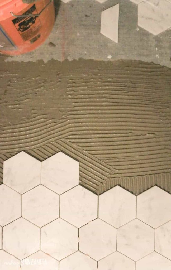 Hexagon marble laid on thin set mortar on floor