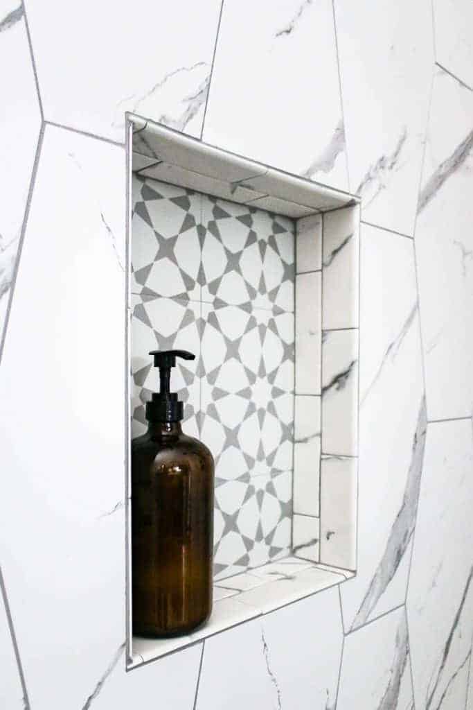 https://www.makingmanzanita.com/wp-content/uploads/2019/10/shower-niche-with-accent-tile-and-amber-glass-bottle-for-shampoo-683x1024.jpg