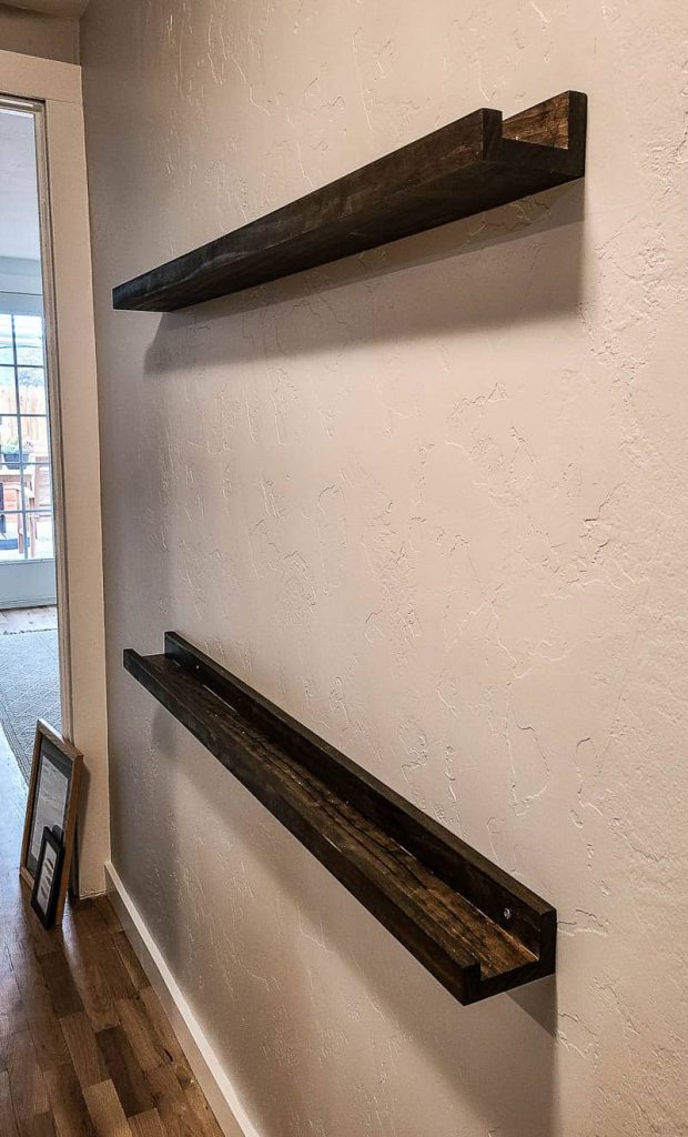 These dark stained DIY picture ledges are an easy DIY that adds a lot of character to a hallway