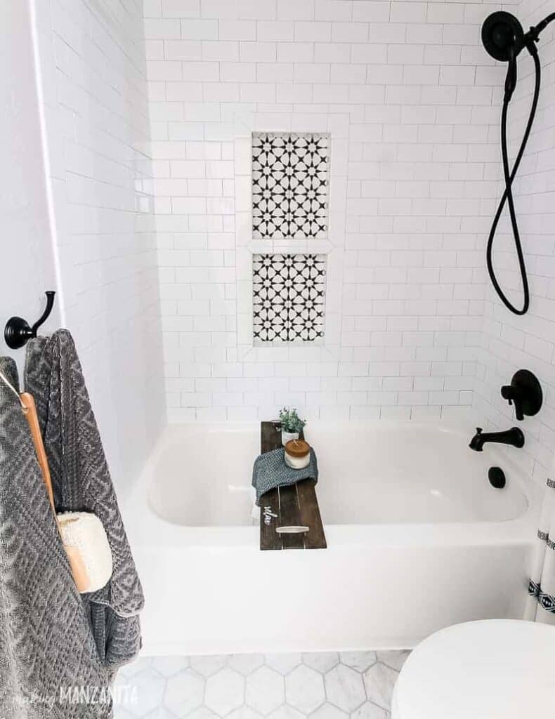 https://www.makingmanzanita.com/wp-content/uploads/2021/12/two-shelf-shower-niche-at-different-heights-in-shower-with-bathtub-790x1024.jpeg