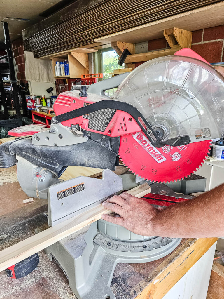 A miter saw being used to cut wood for a Chicknic Table